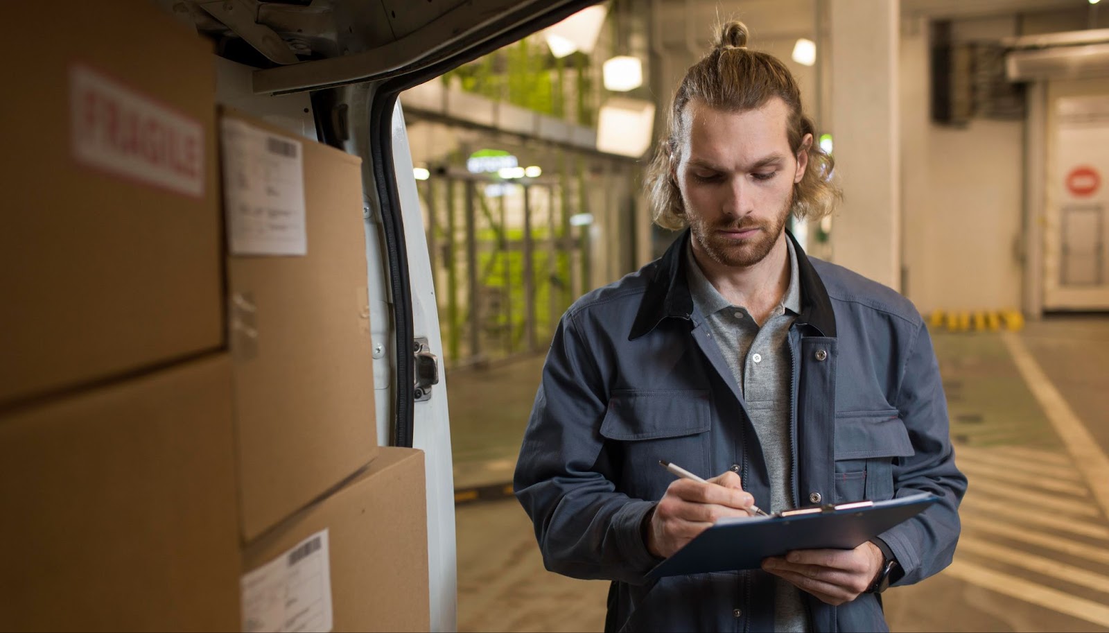 Man with document going to deliver boxes